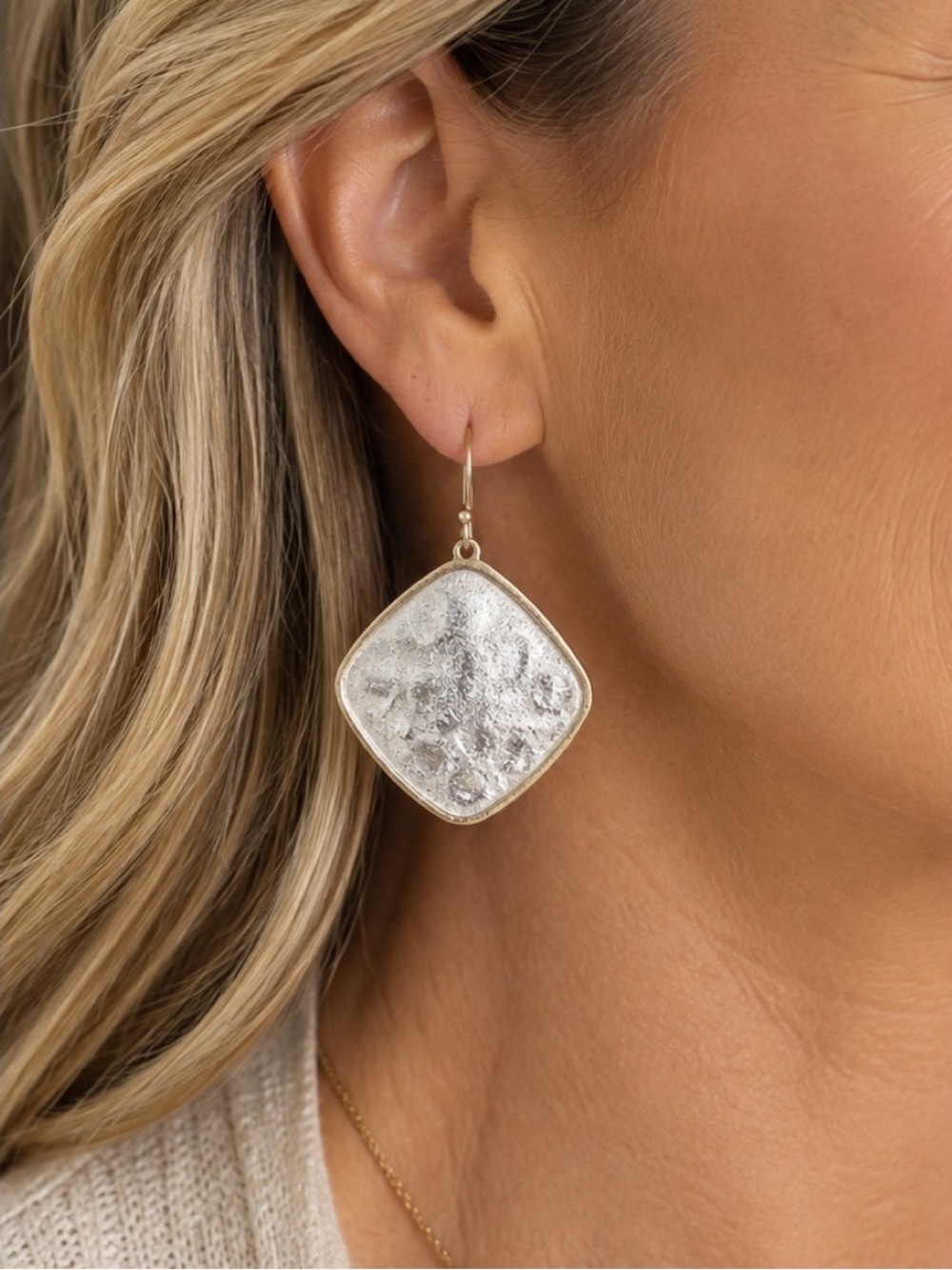 Hammered silver-tone drop earrings feature a rounded diamond-shaped design